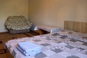 a room with two beds and a table with towels at Apartments on Vostok 5/2 in Bishkek