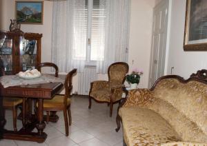 a living room with a couch and a table and chairs at La Casa di Tino in Fontanellato