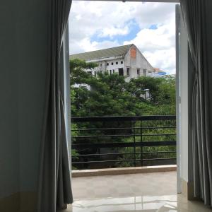 una ventana abierta con vistas a un edificio en Thien Ngoc Hostel, en Can Tho
