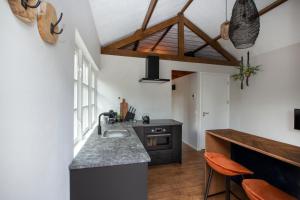 a kitchen with a sink and a counter top at Tukken op de Tol in Velp