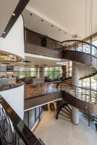 an open lobby with a spiral staircase and a living room at Hotel VEGA Sofia in Sofia