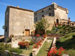 an old building with flowers in front of it at Il Castello di San Sergio in Centola