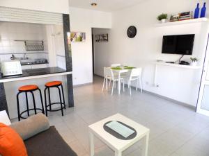 a living room with a couch and a table at Apartamentos Medano - Playa Grande in El Médano +12 photos