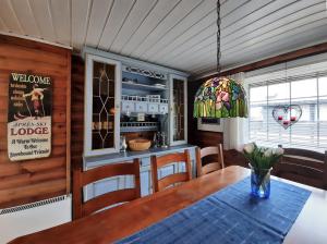 a dining room with a table and chairs at Fidjeland 61 in Tjørhom