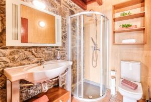 a bathroom with a sink and a shower and a toilet at Seixal Sunny Villa A & B by Amazing Madeira in Seixal +43 photos