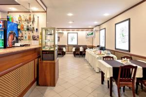 a restaurant with tables and chairs and a counter and a bar at Dubki Hotel in Samara