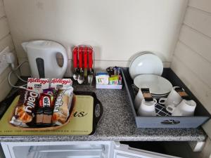 a kitchen counter with food and other items on it at Royal Albion Walton in Walton-on-the-Naze