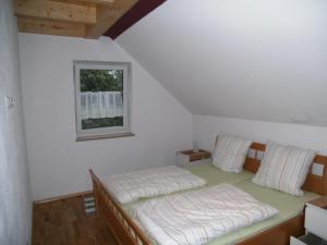 a bedroom with two beds and a window at Ferienhaus Kettler II in Muhr amSee