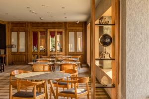 a restaurant with tables and chairs in a room at Las Hayas Ushuaia Resort in Ushuaia