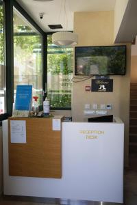 a reception desk in an office with a registration desk at Hotel Alkima in Kotor