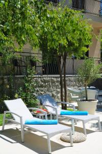 a group of chairs sitting on a patio at Hotel Alkima in Kotor