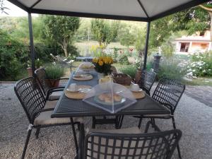 a black table with chairs and food on it at B&B Nonna Rosa in Norcia