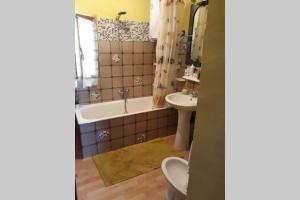 a bathroom with a tub and a toilet and a sink at La Casina al Paesello col Castello in Grotte Santo Stefano