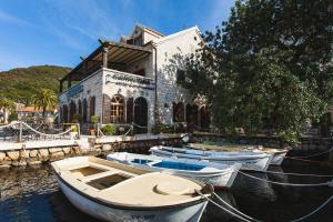 a group of boats docked in front of a building at Eco Hotel Carrubba in Tivat