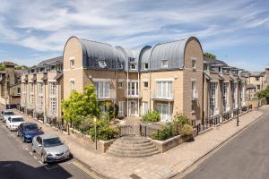 a large brick building with a metal roof on a street at 2 Bedroom City Centre Townhouse - with Parking in Cambridge