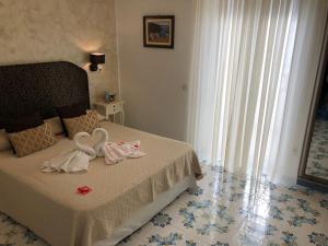 Postel nebo postele na pokoji v ubytování Nonno Francesco B&B