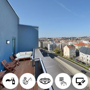 a balcony with a couch and a view of a city at Charming & Cozy Ambiente Apartments in Bratislava