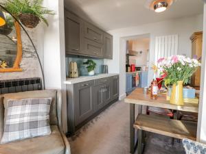 a kitchen with gray cabinets and a wooden table at The Lookout in Barmouth