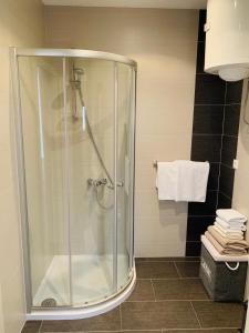 a shower with a glass enclosure in a bathroom at Apartments Villa Zica in Trogir