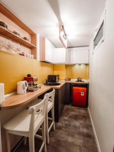 a small kitchen with a counter and a red refrigerator at Old Town Constanta in Constanţa +1 photo