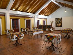 a room with tables and chairs in a building at Hotel Cacique Real in Zipaquirá