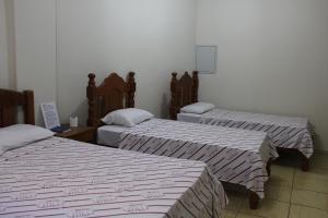 A bed or beds in a room at Hotel Galli