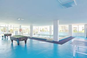 a pool room with a pool table and a pool table at Hotel Arenal in San Antonio