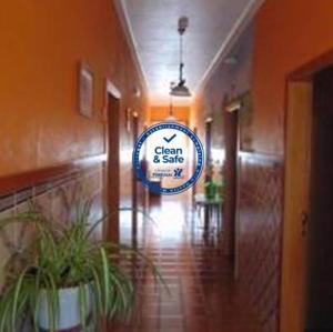 a hallway with a sign for a clean and safe office at Residencial as Canárias in Ponte de Sor