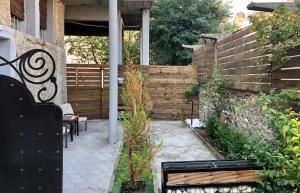a patio with a bench and a brick wall at Meteora House- Cozy Living in Kalabaka