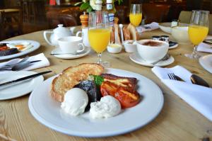 a table with a plate of breakfast food on it at Harper's Steakhouse with Rooms, Haslemere in Haslemere