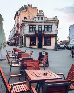 a group of tables and chairs in front of a building at Old Town Constanta in Constanţa