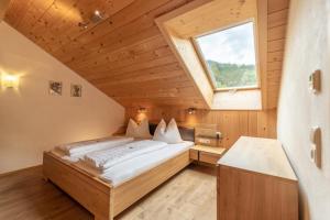 a bedroom with a bed in a room with a window at Forsthaus Schoppernau in Schoppernau