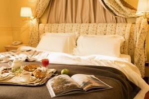 
a bed with a blanket and pillows on top of it at Grand Hotel Royal E Golf in Courmayeur
