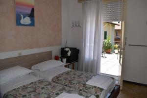 
a bedroom with a bed and a dresser at Villa Emma in Nago-Torbole
