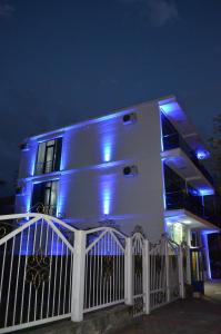 a white house with blue lights on it at White Hotel in K'obulet'i