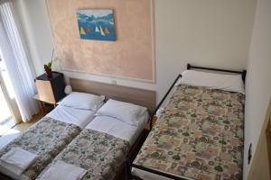 
a bedroom with two beds and a window at Villa Emma in Nago-Torbole
