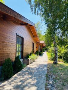 a house with a pathway next to a building at Friends Bungalows in Kŭrdzhali