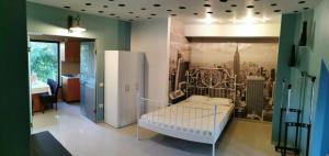 a bedroom with a white bed and a refrigerator at Vila Zuzette in Constanţa