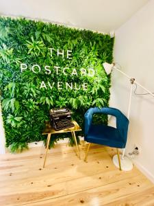 a room with a green wall with a desk and a chair at The Postcard Avenue in Lisbon