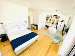 a bedroom with a bed and a bathroom with a tub at The Postcard Avenue in Lisbon