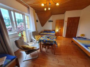 a living room with a table and a bed at Žltý dom Vrbov in Vrbov