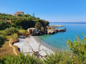 a beach with people swimming in the water at Gkionis Apartment in Kalamata