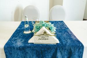 a blue table with a napkin and a glass at Iridium Hotel in Taif