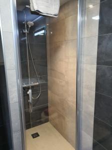 a shower with a glass door in a bathroom at Maison de Laveline in Laveline