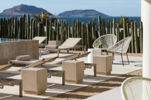 a group of chairs and tables on a patio at Hotel Boutique Casa Lulu in Mazatlán