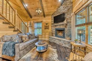 a living room with a couch and a fireplace at Noir Pine Creekside Chalet in Gatlinburg