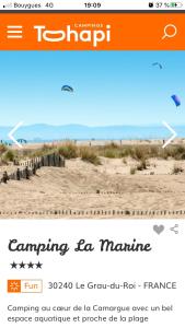 
an aerial view of a large group of people flying kites at CAMPING LE MARINE in Le Grau-du-Roi
