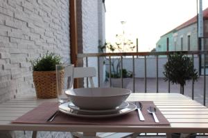 a bowl sitting on a table on a balcony at Alumar Apartamentos Muxia in Muxia