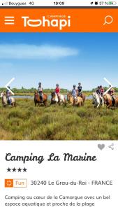 
a man riding on the back of a horse at CAMPING LE MARINE in Le Grau-du-Roi
