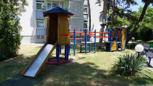 a playground in a park with a slide at Elite Apartments in Sunny Beach